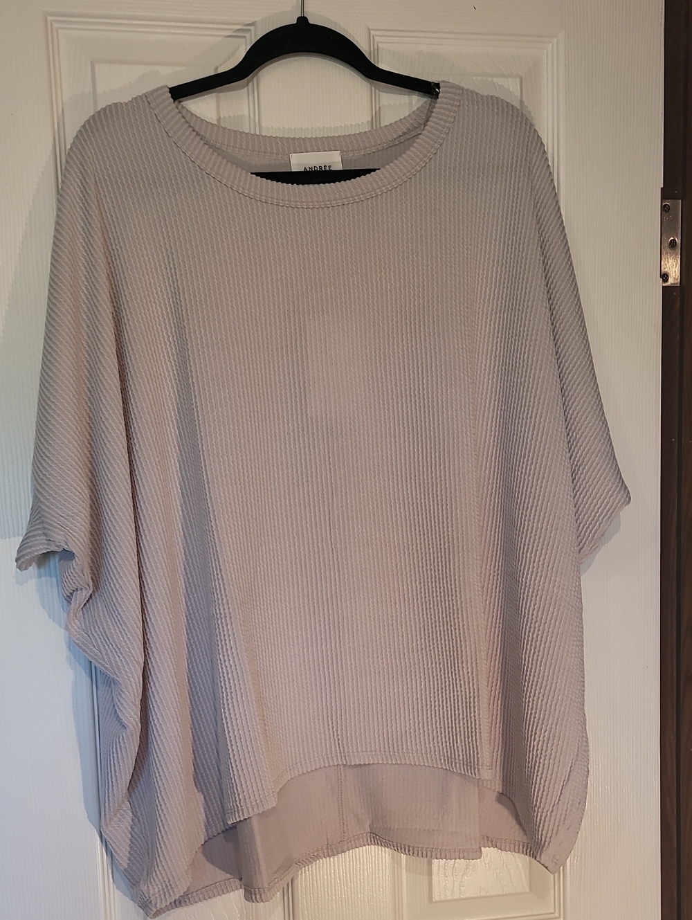 This is a taupe grey oversized ribbed dolman sleeve poncho tunic top